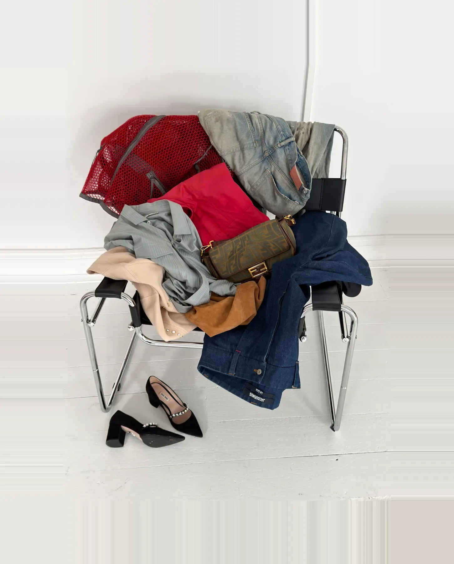 An armful of clothing piled up, ready to photograph for a Ragpiq listing